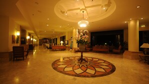 A spacious lobby with a central floral arrangement, a chandelier, and a patterned floor. - Langkawi Lagoon Resort (Langkawi)