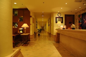 A hotel reception area with a long corridor, a reception desk, and a clock on the wall. - Langkawi Lagoon Resort (Langkawi)