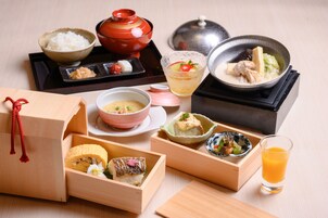Una presentación tradicional de comida japonesa, con varios platos y una tetera.