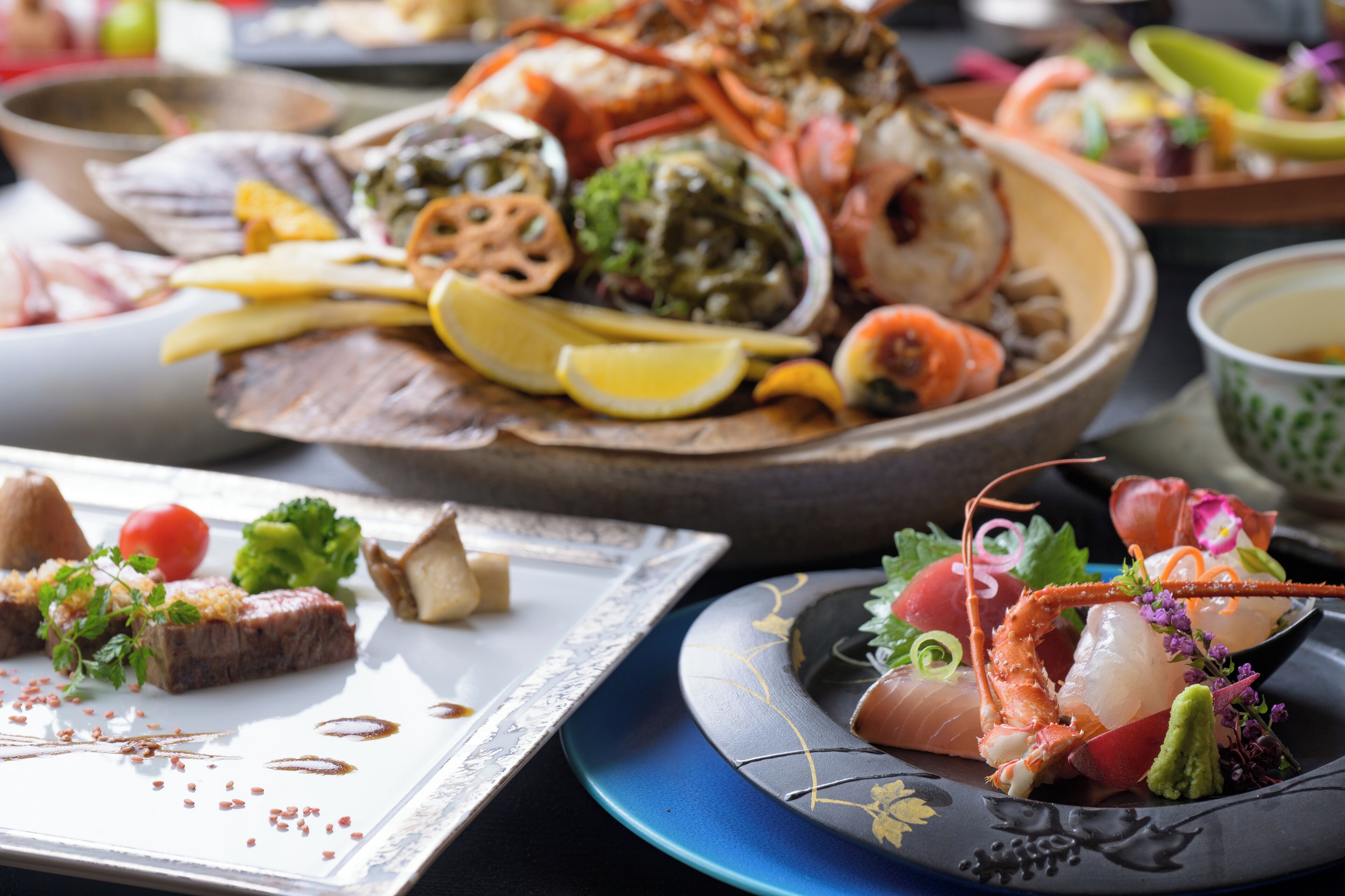 A variety of seafood dishes on a table, including lobster, shrimp, and other seafood items.