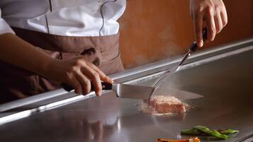 A person preparing food on a grill.