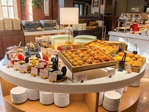A buffet with various food items and utensils, arranged on a white table with labels. - Rusutsu Resort Hotel & Convention (Rusutsu)
