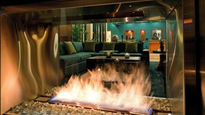 A modern lobby with a glass fireplace, a reception desk, and a green sofa. - Residence Inn by Marriott Cincinnati Downtown/The Phelps (Cincinnati)