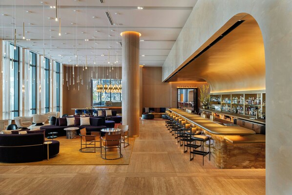 A modern bar area with seating and a bar counter.