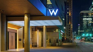 A hotel entrance with a prominent 'W' sign, large columns, and a covered walkway. - W Austin (Austin)