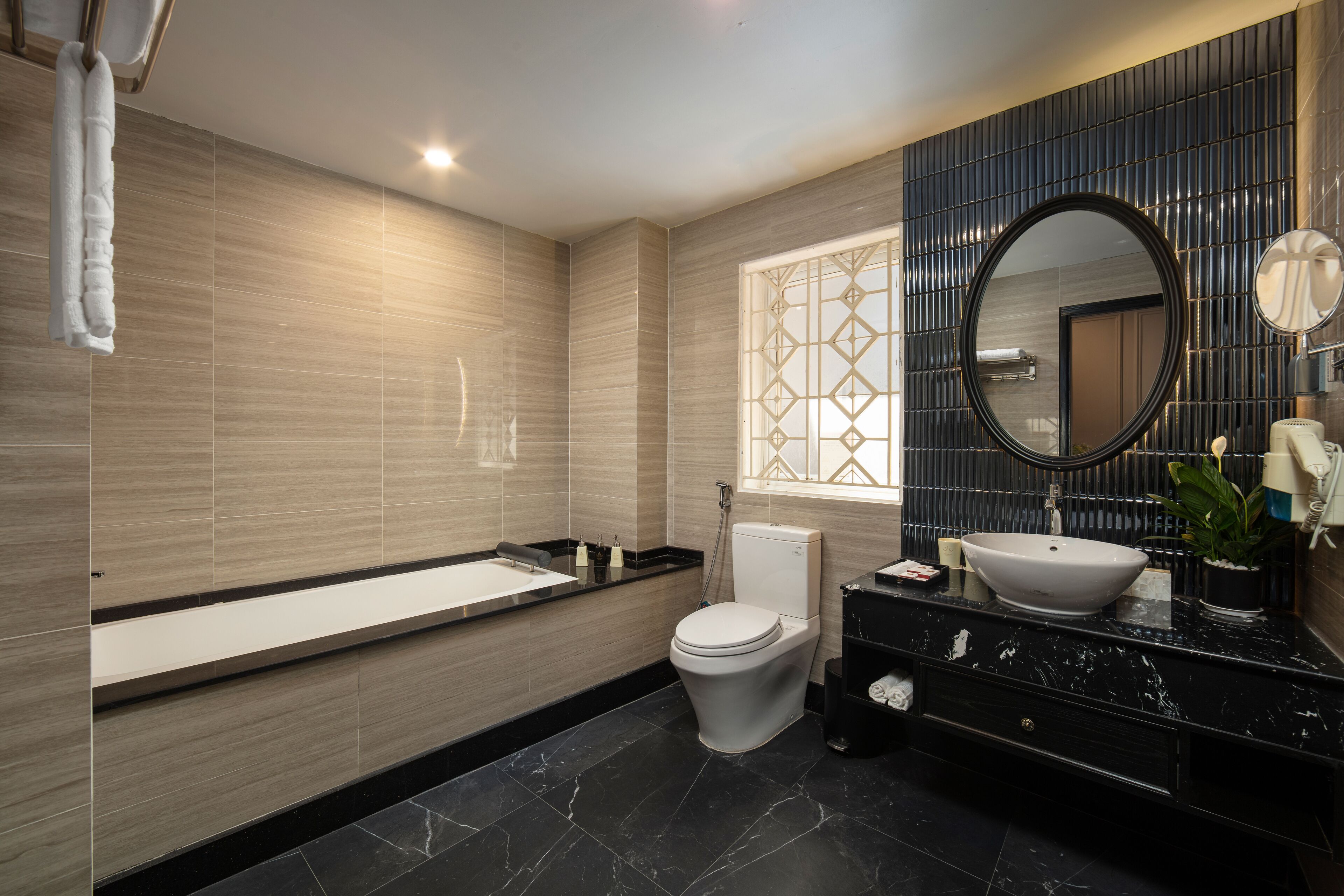 deep-soaking bathtub, rainfall showerhead, designer toiletries