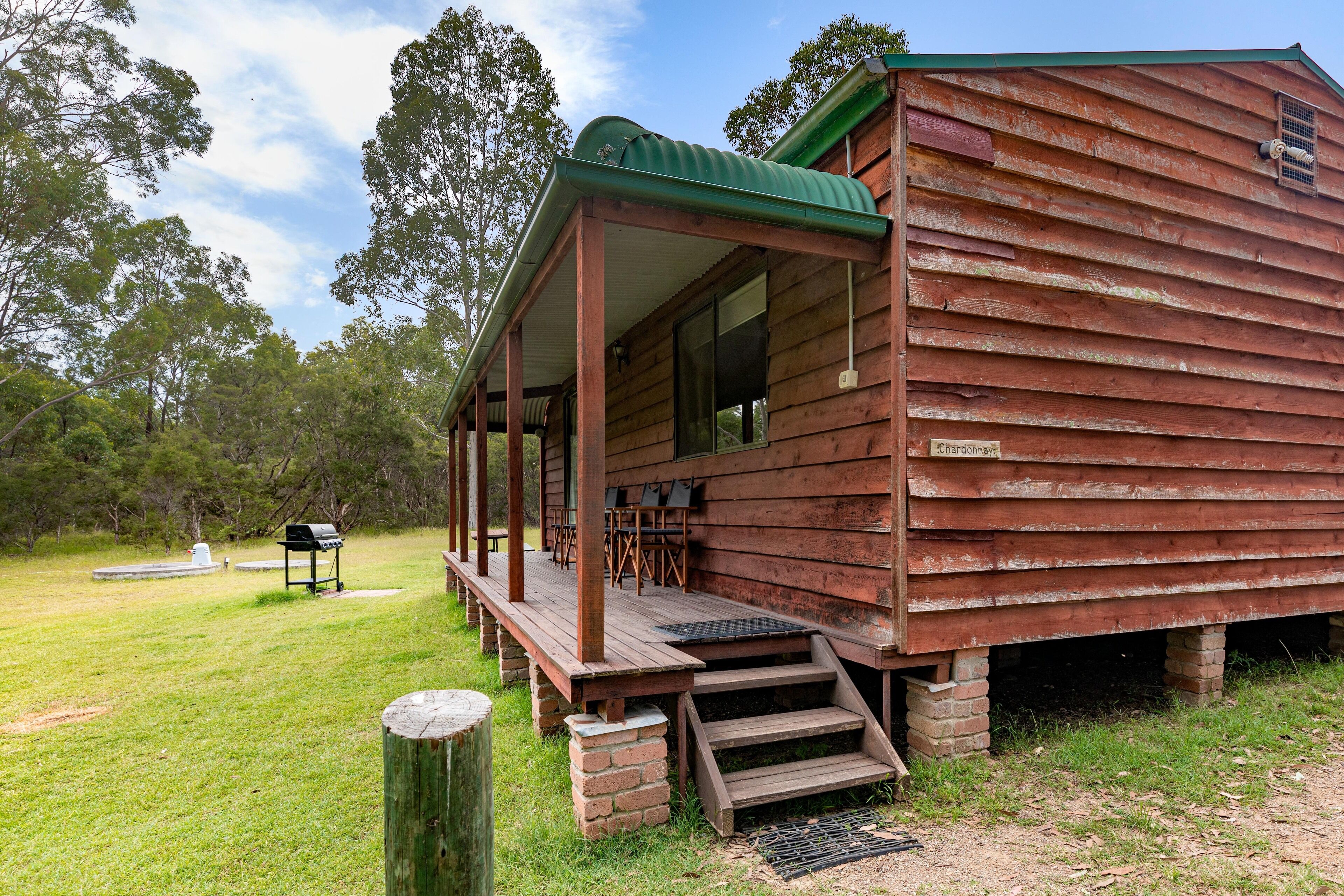 A rustic wooden cabin with a porch, a grill, and a sign reading "Sullivan's."