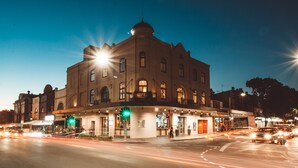 A historic building with a corner entrance, multiple windows, and a dome on top. - Crown Hotel Surry Hills (Surry Hills)