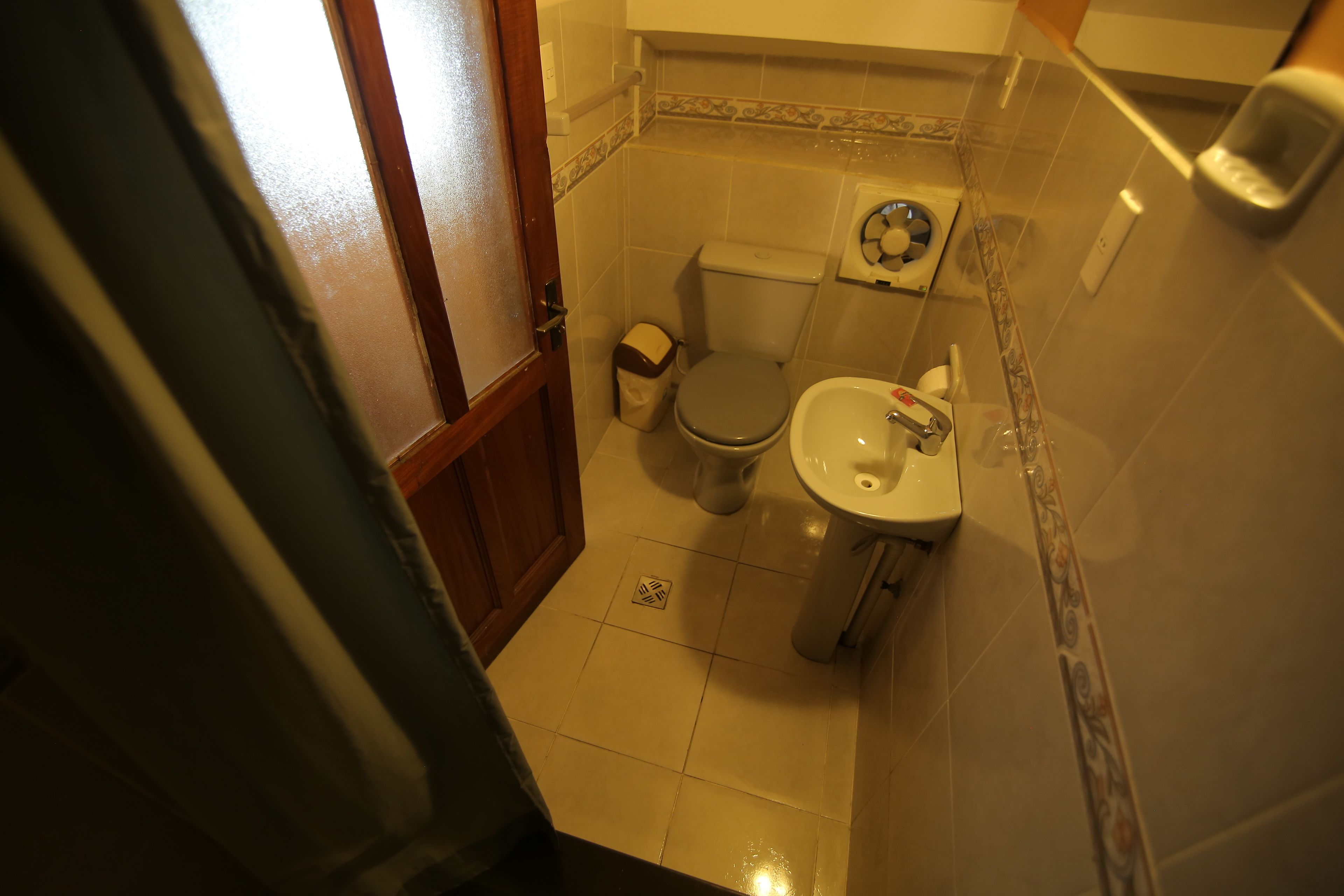 A small bathroom with a toilet, bidet, and sink.
