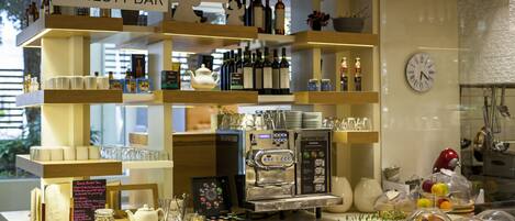 A bar area with shelves of bottles, glasses, and a coffee machine.