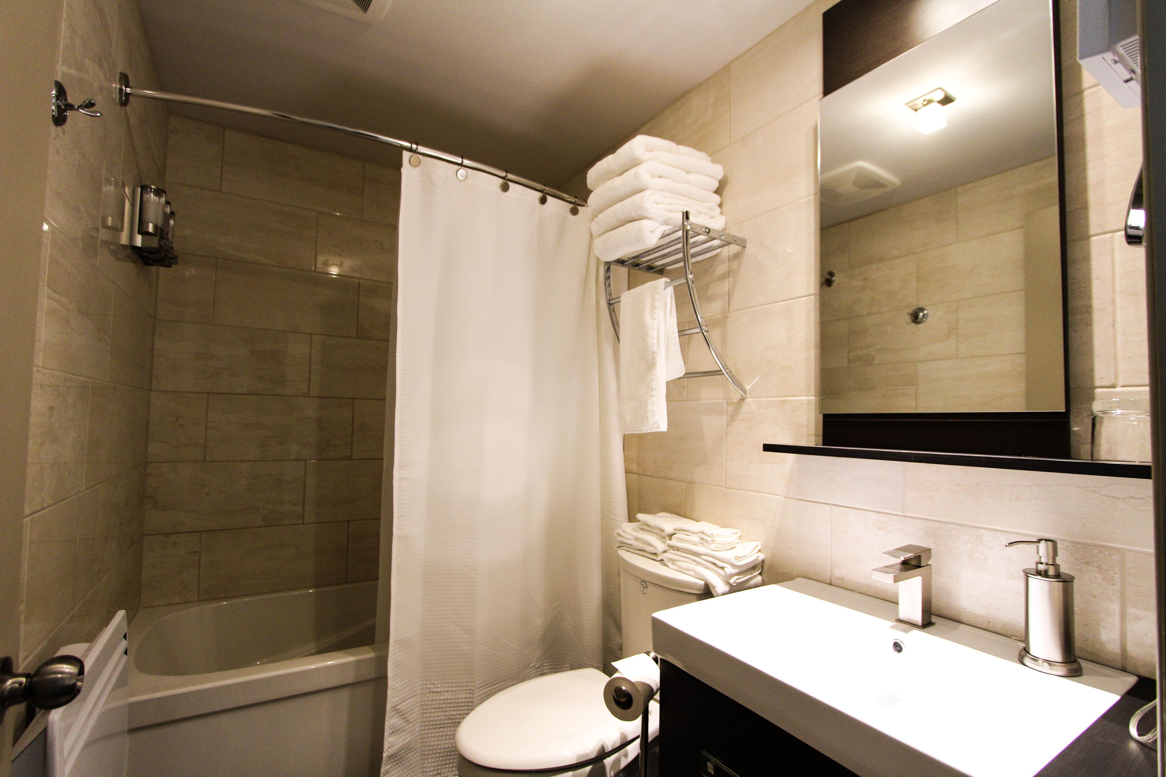 combined shower/bathtub, designer toiletries, hair dryer, bathrobes
