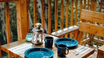 A wooden table with blue plates, a lantern, and a glass jar.