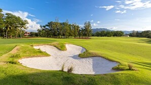 A golf course with sand bunkers, trees, and a clear sky. - The Bell Pool Villa Resort (Kamala)