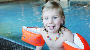 Guests can enjoy a refreshing swim in the indoor pool, surrounded by comfortable lounge seating.