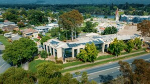 An aerial view of The Select Inn with solar panels, surrounded by greenery and a road. - The Select Inn Penrith (Penrith)