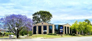 A modern hotel with a prominent sign reading "The Select Inn".