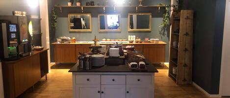 A modern kitchen with wooden cabinets, a central island, and a bar area.