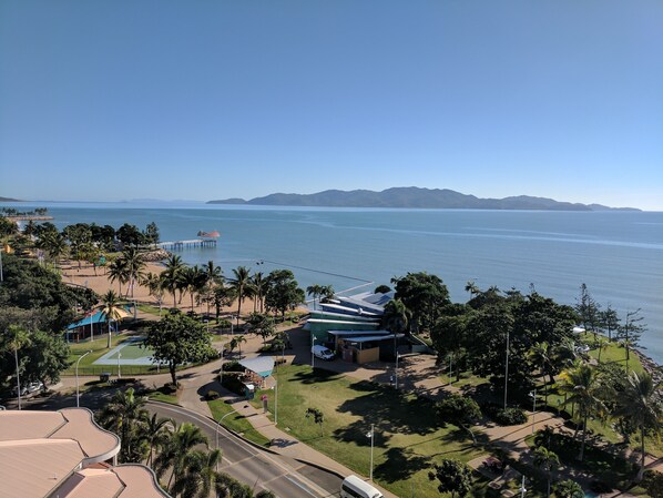A coastal resort with a beach, palm trees, and a pier. - Aquarius on the Beach (North Ward)