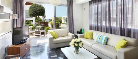 A modern living room with a sofa, coffee table, and TV.