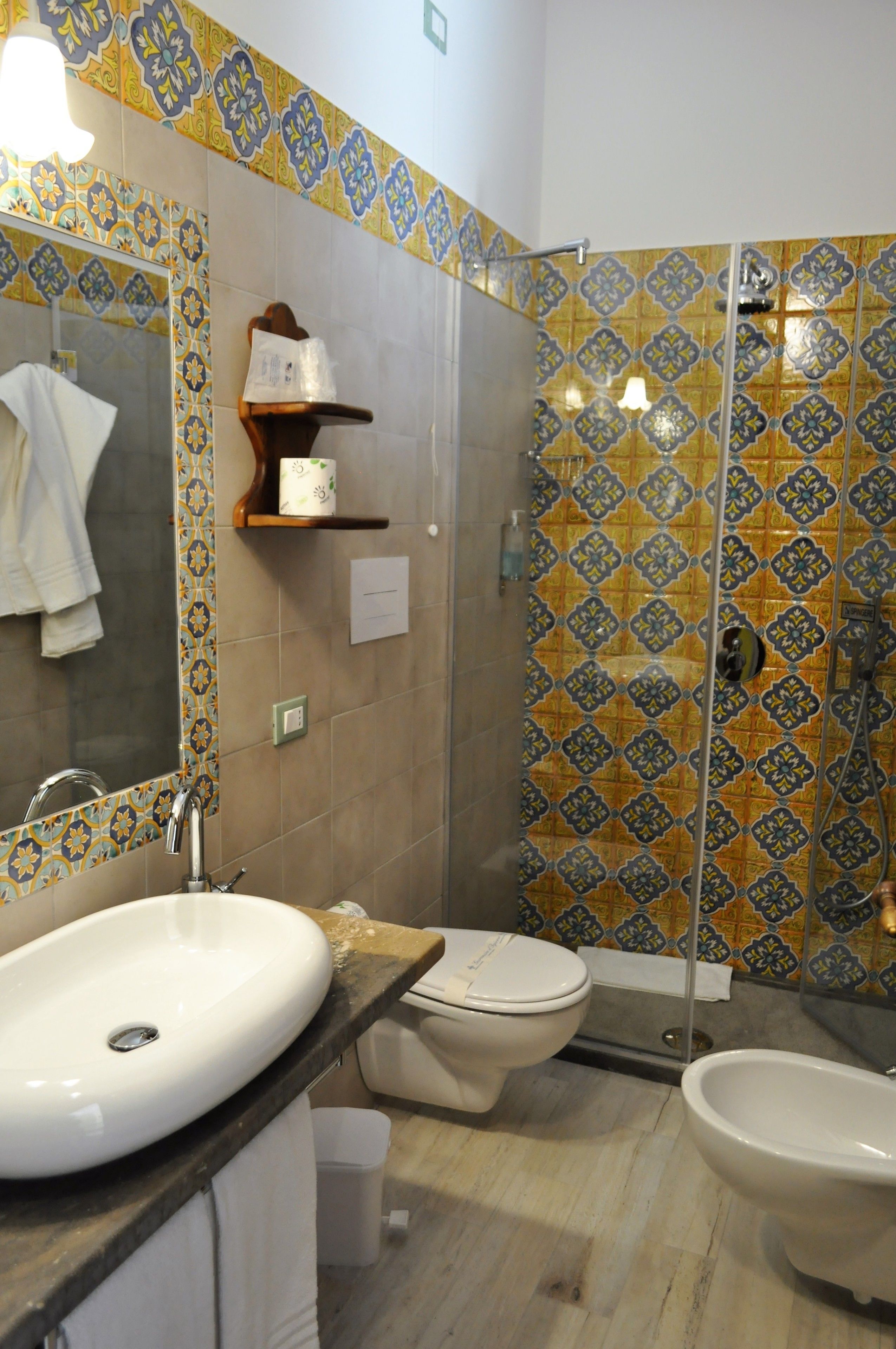 A bathroom with a sink, toilet, and shower area.