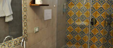 A bathroom with a sink, toilet, and shower area.