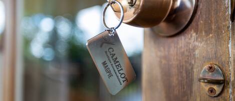 A brass door handle with a keychain attached.