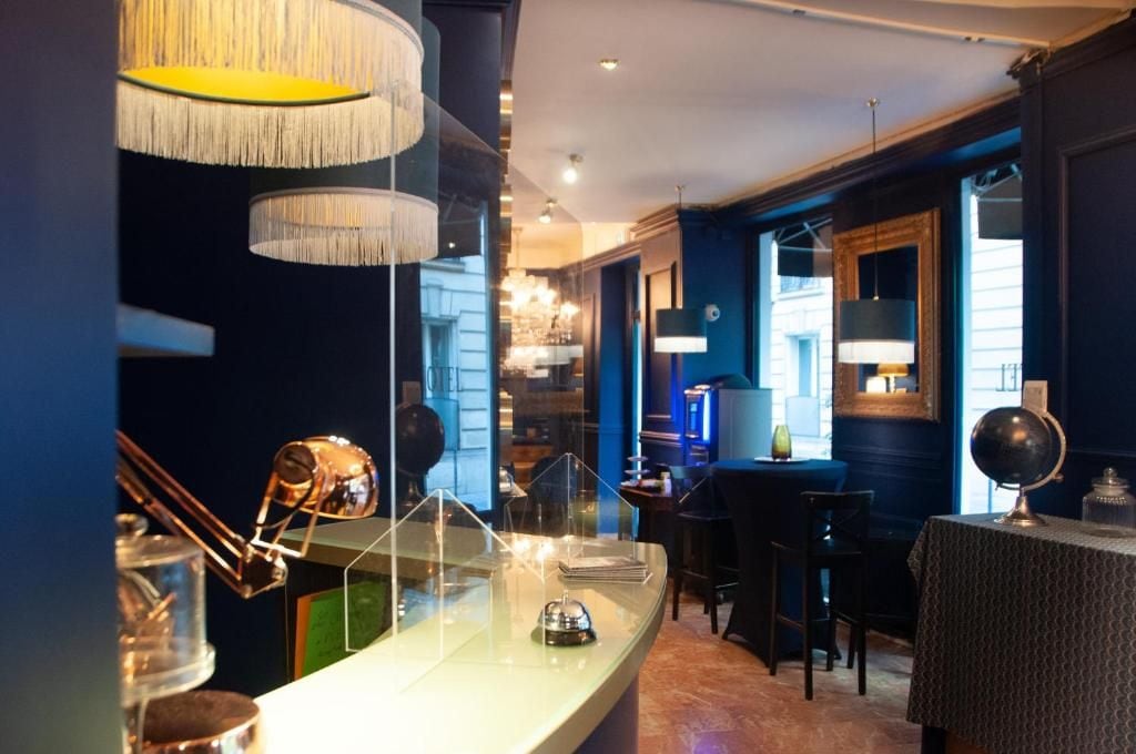 A bar area with a counter, bar stools, and a globe on the table.