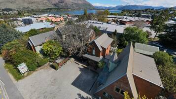 A residential area with houses, a parking lot, and a mountain backdrop.