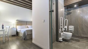 A modern bathroom with a glass shower enclosure, a toilet, and a sink.