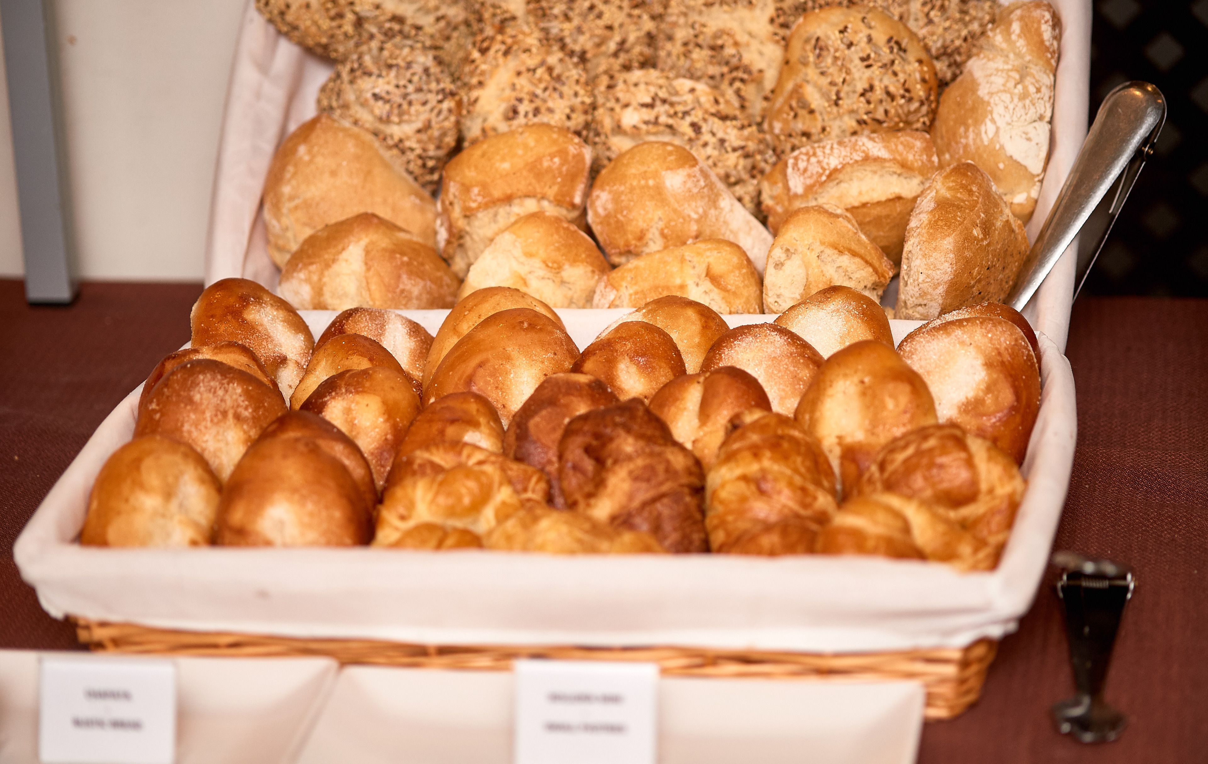 A variety of breads and pastries displayed in a basket.