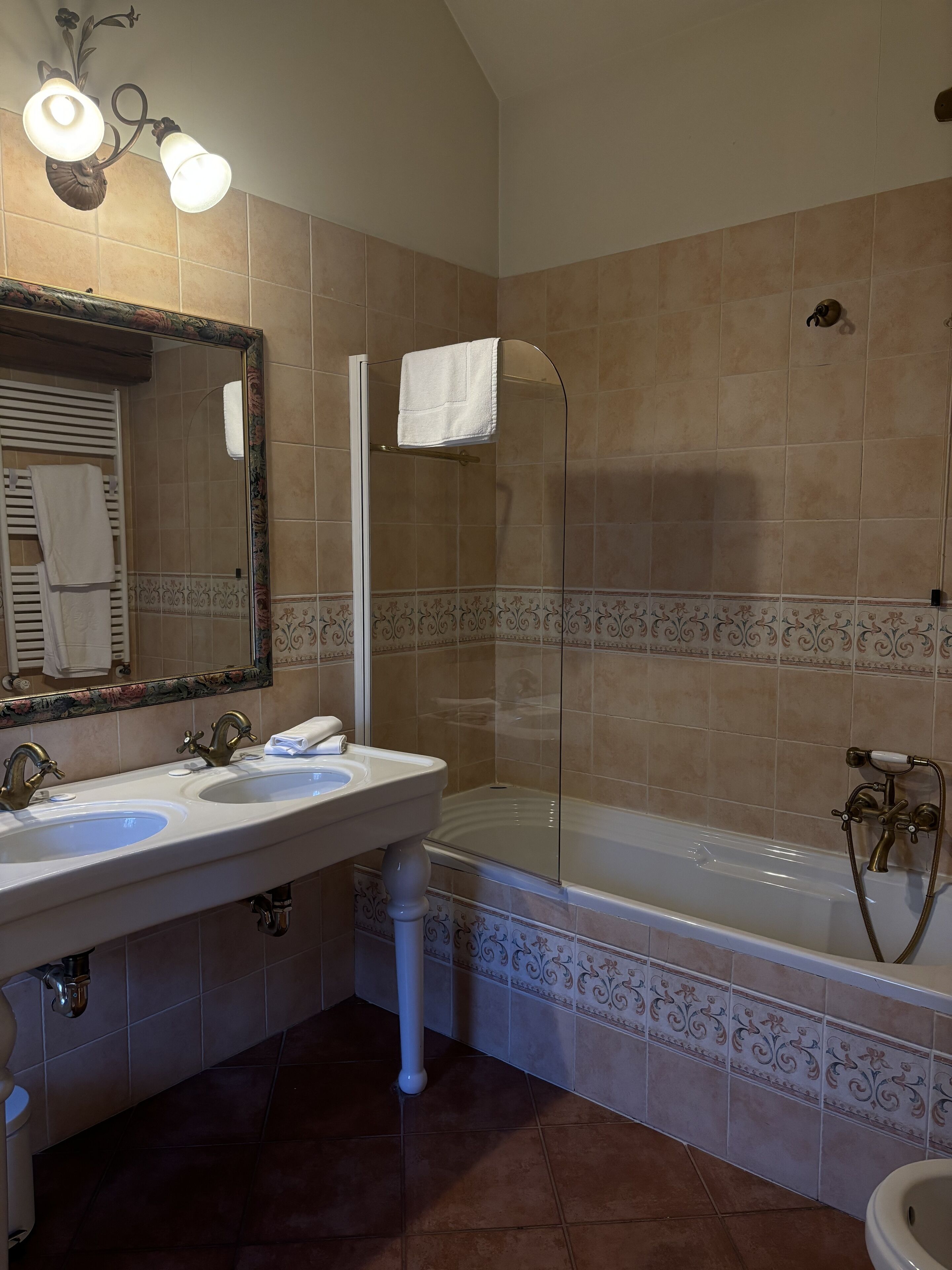 A bathroom with two sinks, a bathtub, and a shower.
