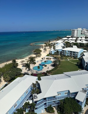 A resort with multiple buildings, a beach, and a pool area. - The Grandview Condos on Seven Mile Beach (Seven Mile Beach)
