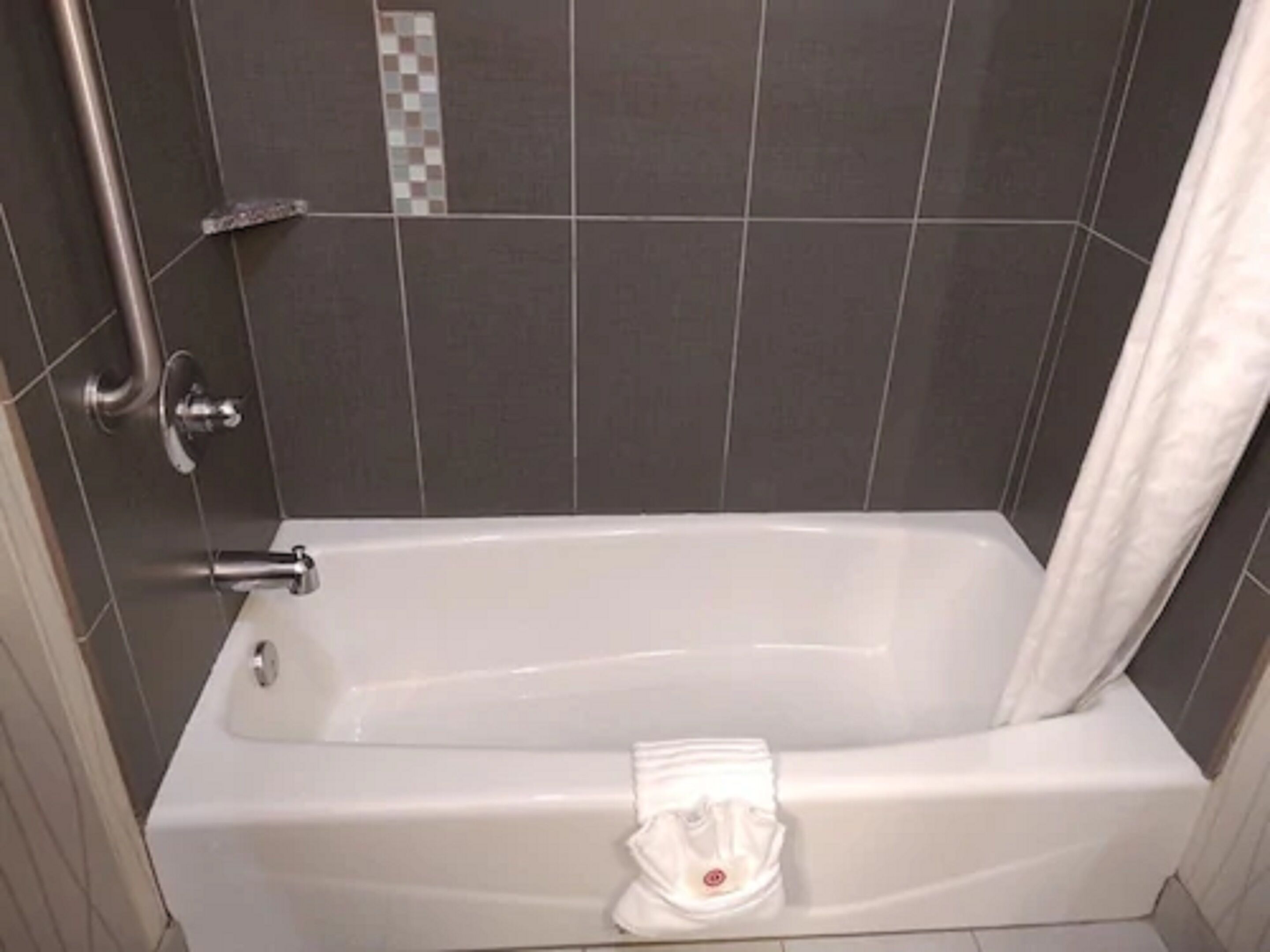 A standard hotel bathroom with a bathtub, a shower, and a toilet.