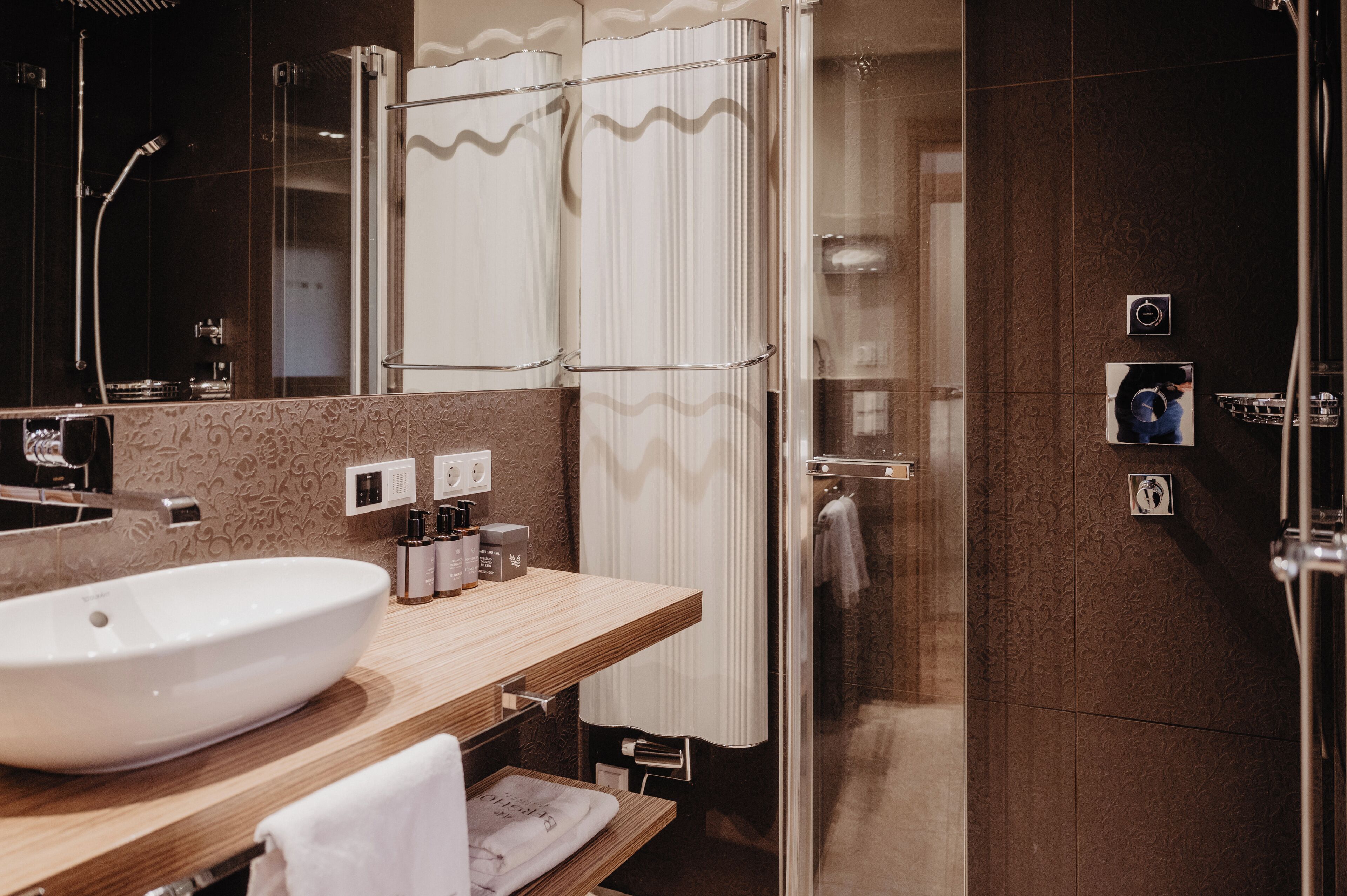 junior suite deluxe | bathroom | shower, rainfall showerhead, designer toiletries, hair dryer
