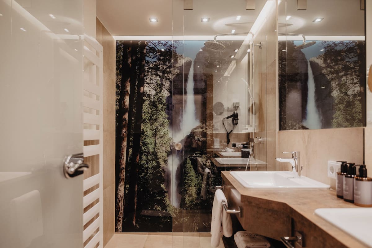 berghof suite deluxe | bathroom | shower, rainfall showerhead, designer toiletries, hair dryer