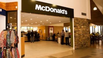 A McDonald's restaurant with a stone facade and a tiled floor.