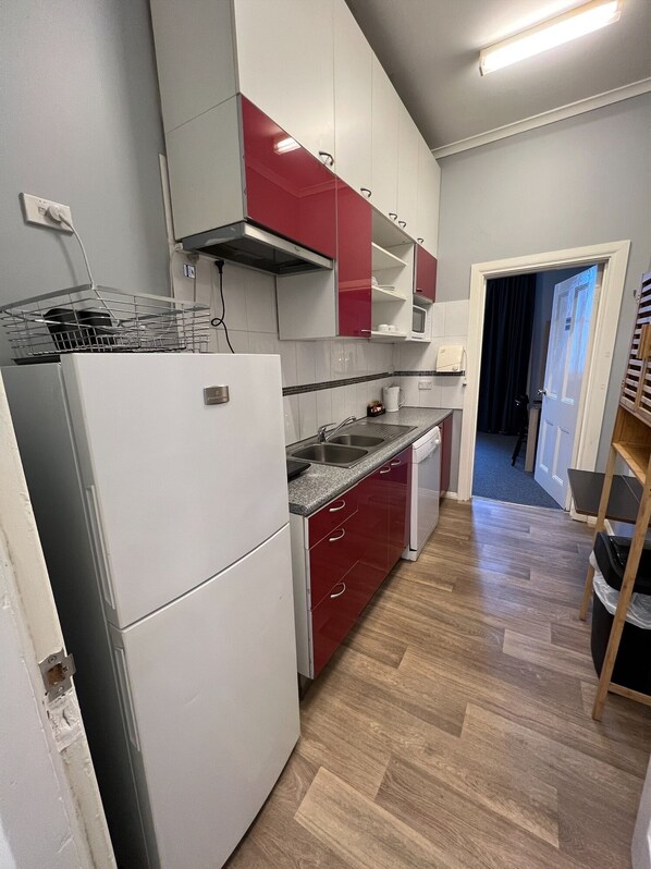 Kitchen features a double sink, granite countertop, and a small window above the sink.