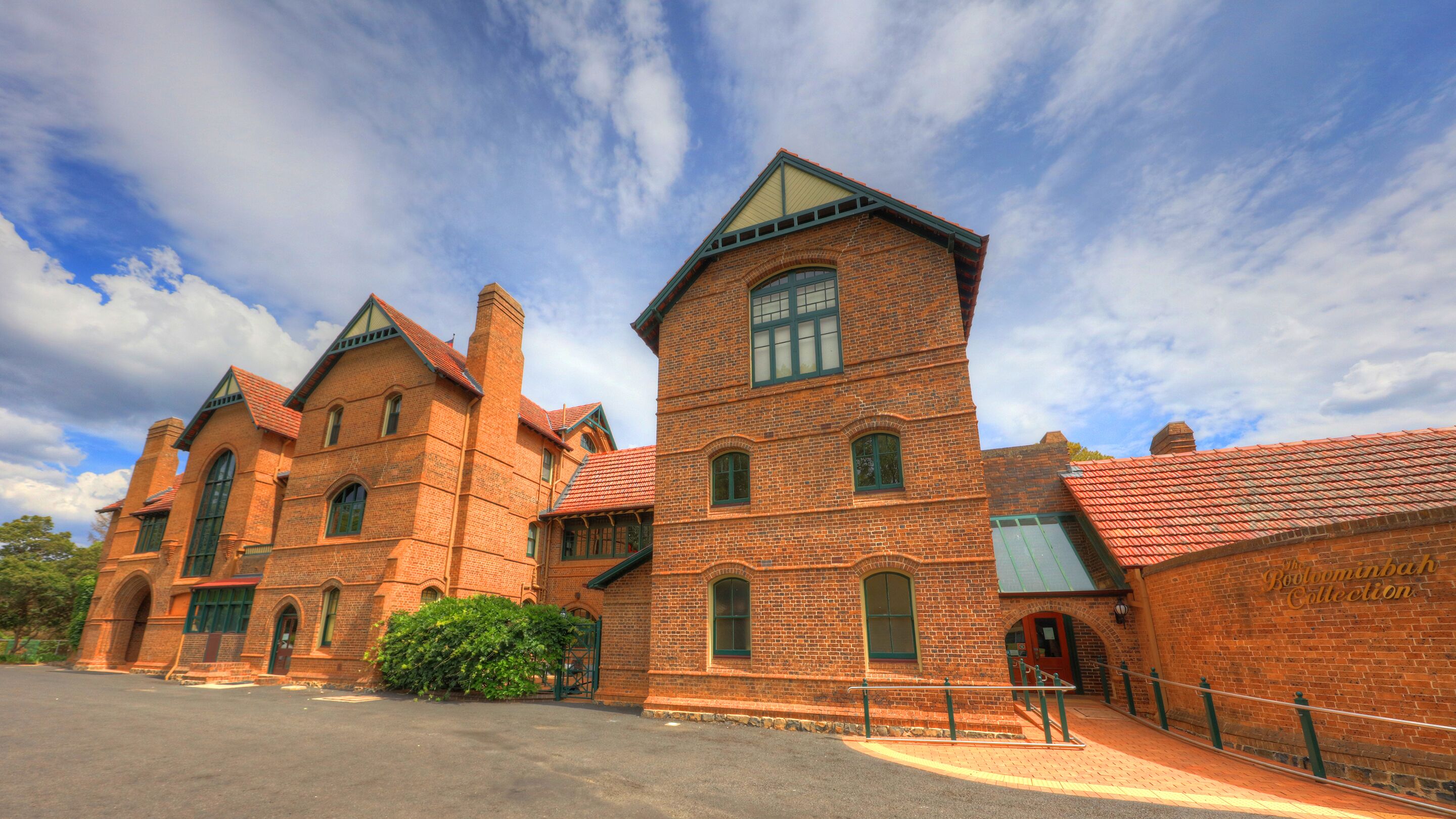 A large brick building with multiple towers and arched windows, likely a historic or institutional building.