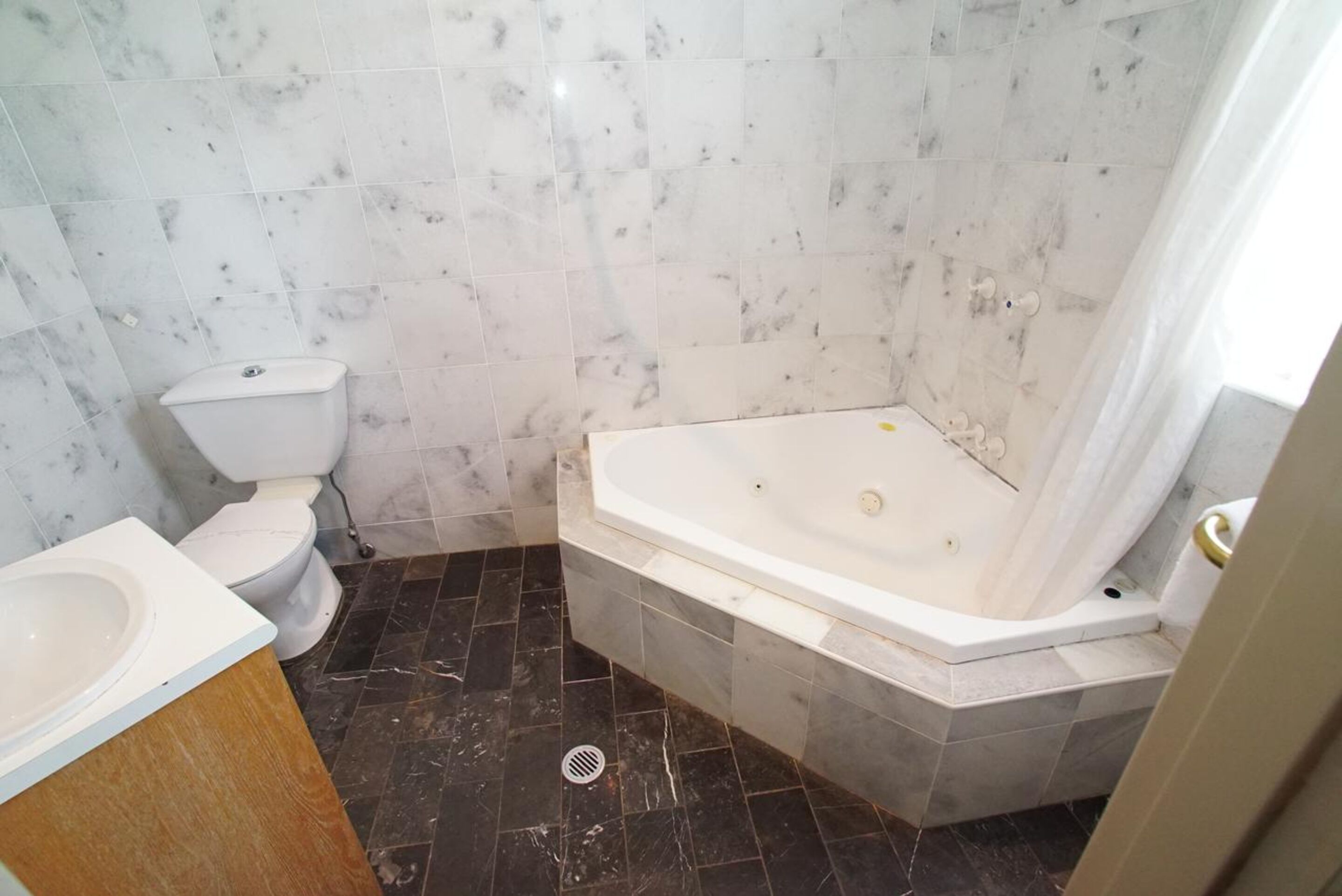 A bathroom with a toilet, a sink, and a bathtub.