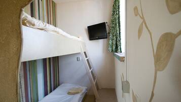 Enjoy a comfortable stay with a bunk bed and single bed, a TV, and a window with a curtain.