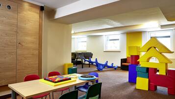 Children can play and learn in this room with a play structure, table, and puzzle.