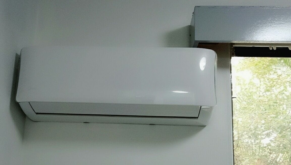 A white air conditioning unit mounted on a wall.