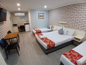 A hotel room with two beds, a desk, a microwave, and a small kitchenette. - Alfa Motel (Gilgandra)