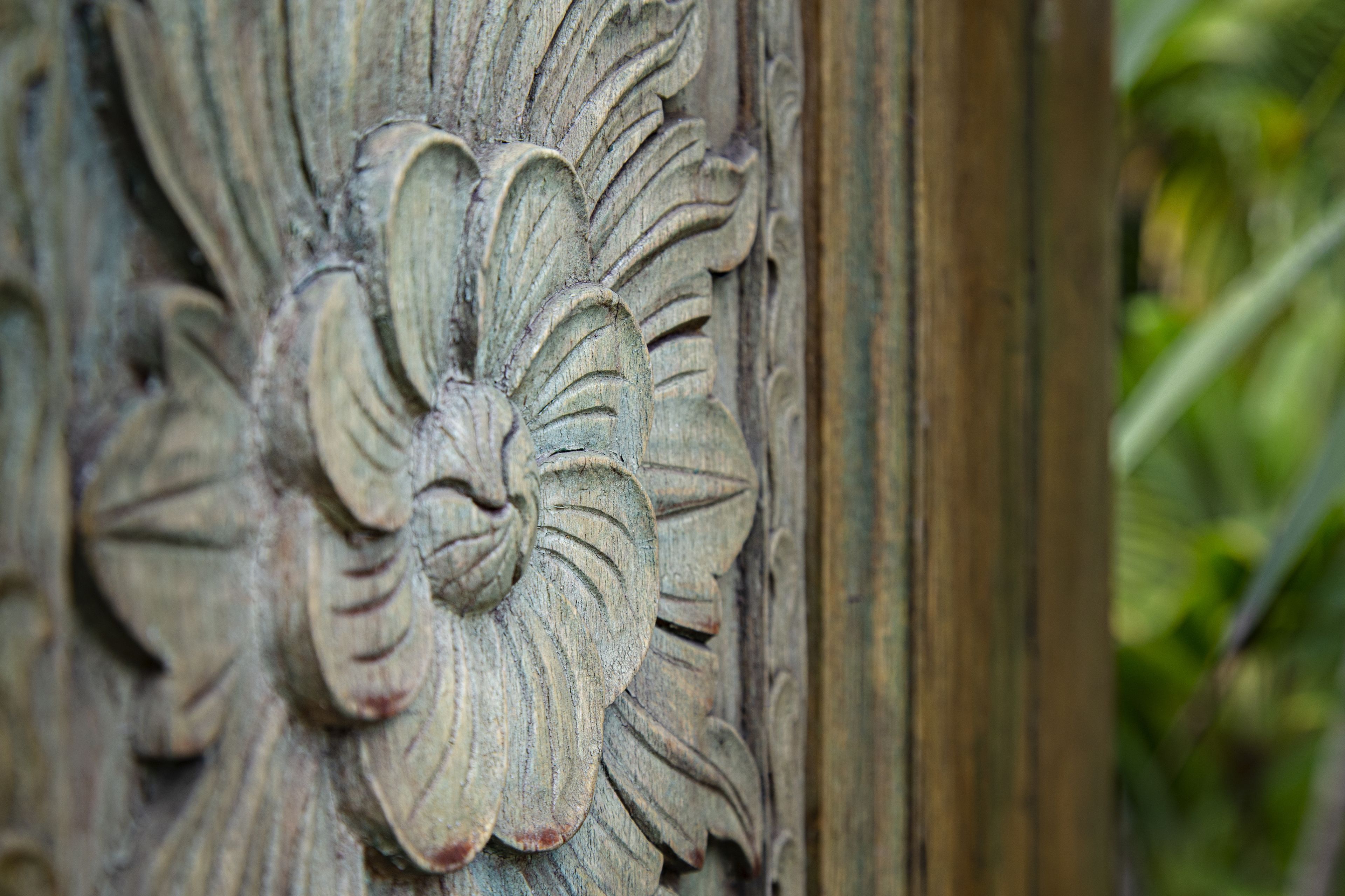 A close-up of a carved wooden panel with a floral design.