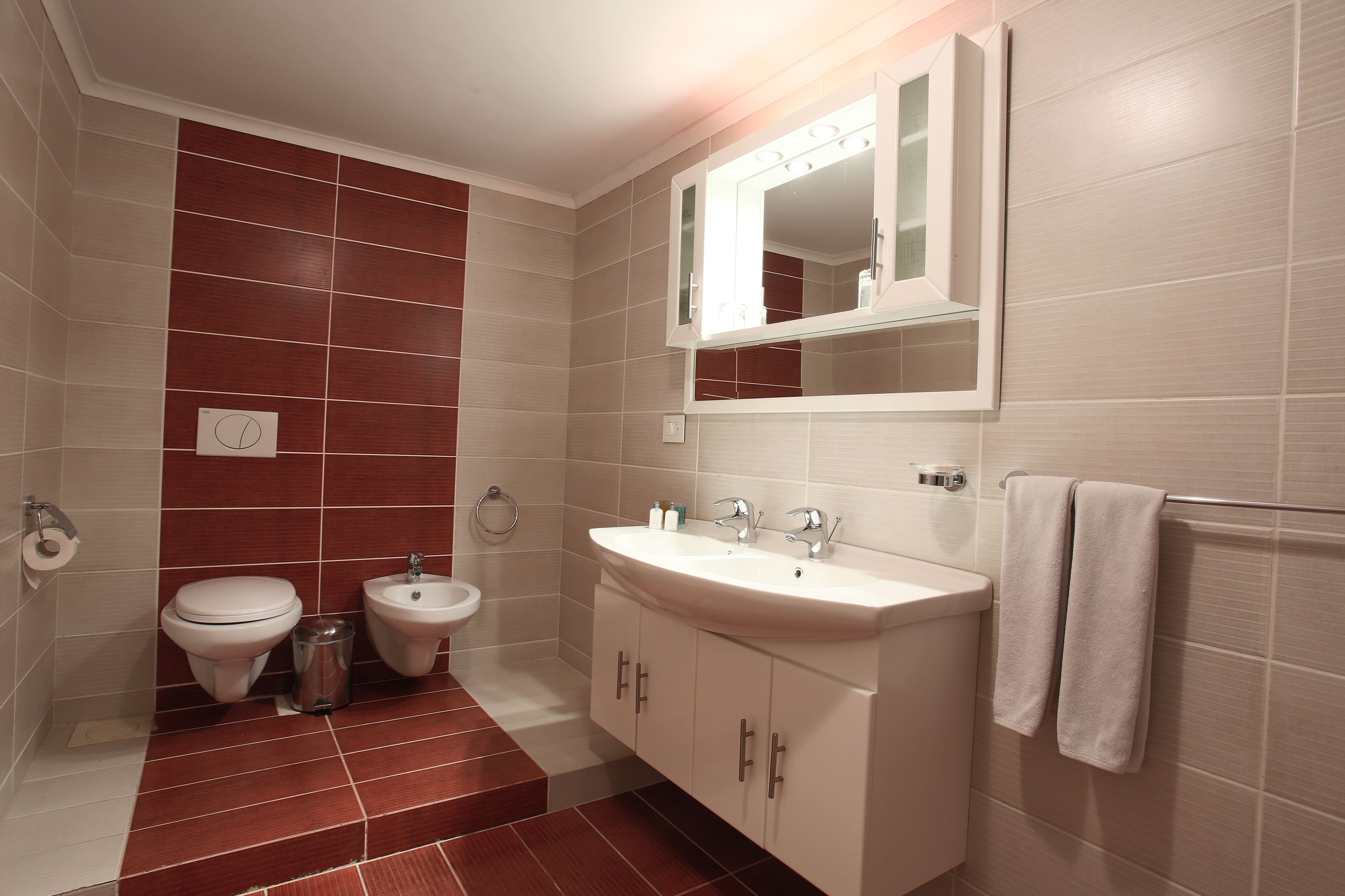 rainfall showerhead, designer toiletries, hair dryer, slippers