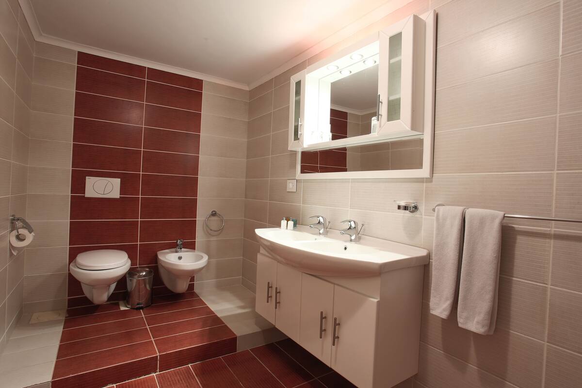 rainfall showerhead, designer toiletries, hair dryer, slippers