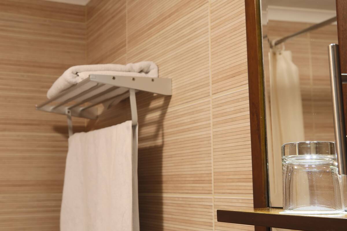 rainfall showerhead, designer toiletries, hair dryer, slippers