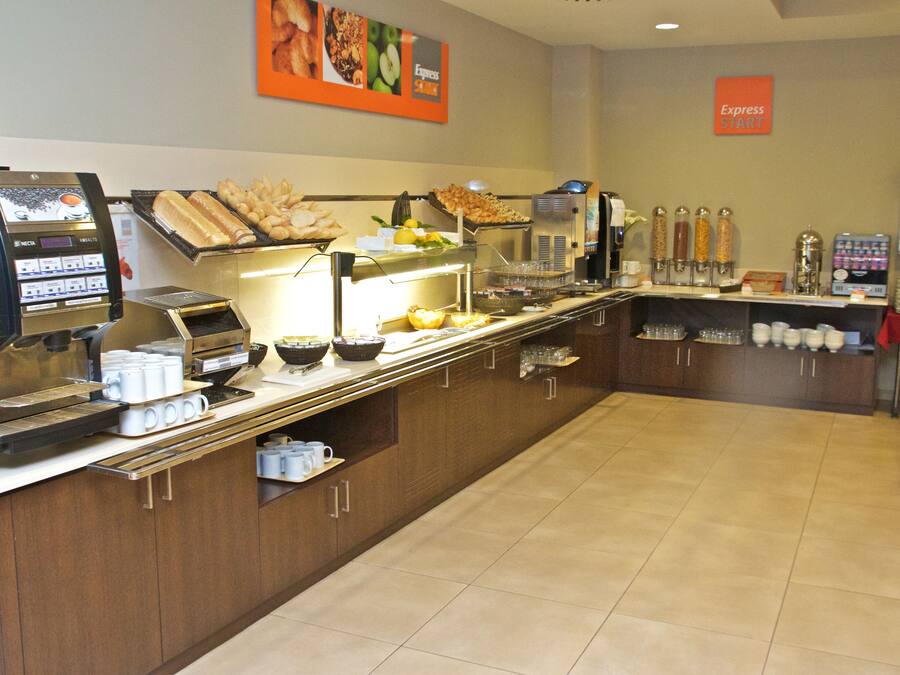 A buffet area with a coffee machine, various food items, and a sign indicating the Express Start location.