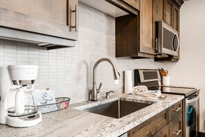 2-Bedroom Condominium #22 | Private kitchen | Full-size fridge, microwave, stovetop, dishwasher