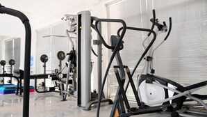 A gym with various exercise equipment, including a rowing machine and a stationary bike. - Apo Apartments (Abuja)